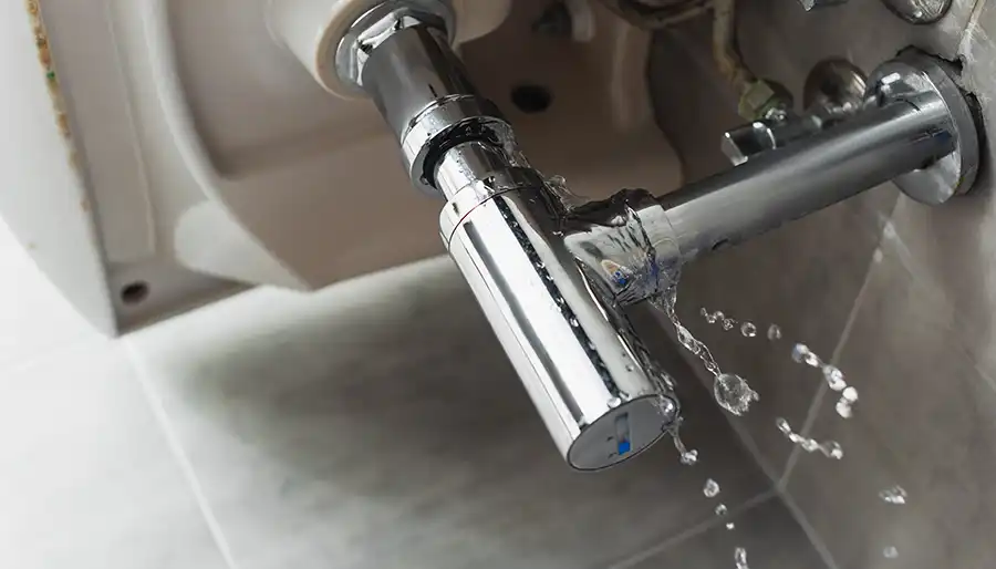 Water leaking from a damaged pipe during residential plumbing repair