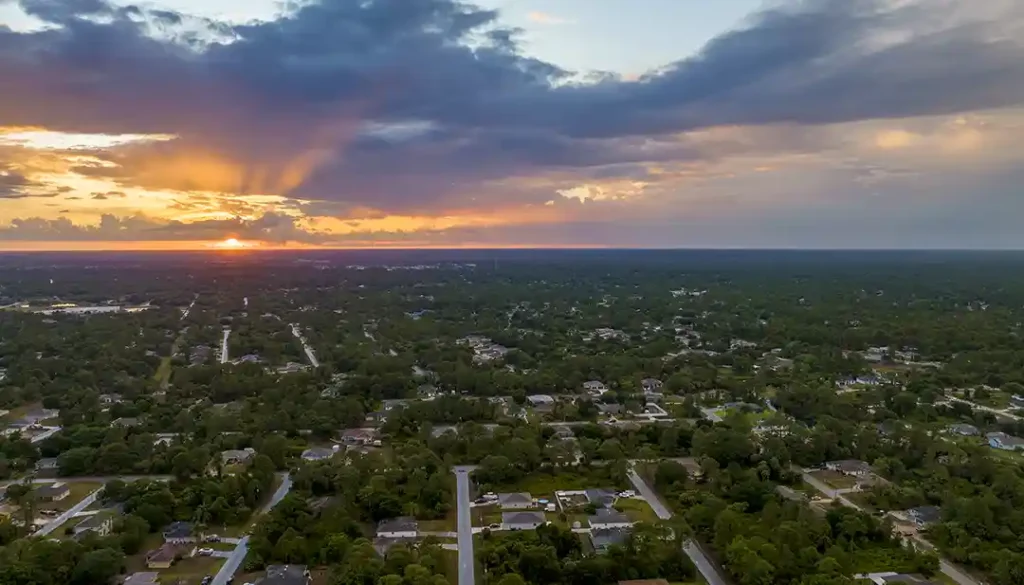 Residential streets in North Port, Florida, showing local homes and trees during sunset