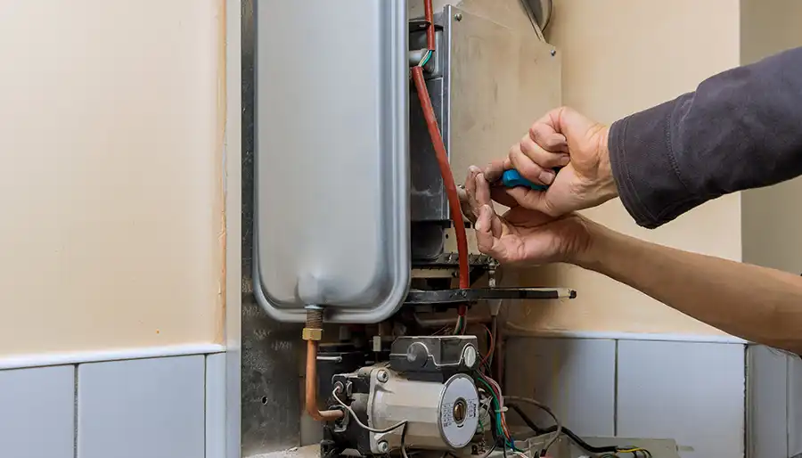 Modern tankless water heater installed on wall in residential home
